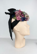 Load image into Gallery viewer, Original 1940’s Black Topper Hat with Pastel Flowers in Pink, Purple and Blue and Huge Bow Trim *