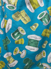 Load image into Gallery viewer, Original 1950's Novelty Print Cotton Apron with Sewing Theme in Blue, Yellow and Green - Waist 38 40
