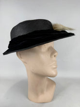 Load image into Gallery viewer, Original Early 20th Century Black Straw Hat with Velvet Covered Brim and Ivory Coloured Feather Trim *
