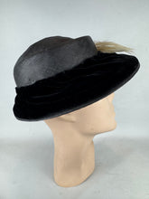 Load image into Gallery viewer, Original Early 20th Century Black Straw Hat with Velvet Covered Brim and Ivory Coloured Feather Trim *