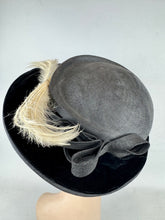 Load image into Gallery viewer, Original Early 20th Century Black Straw Hat with Velvet Covered Brim and Ivory Coloured Feather Trim *