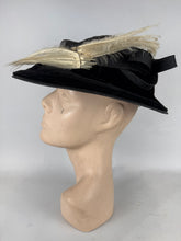 Load image into Gallery viewer, Original Early 20th Century Black Straw Hat with Velvet Covered Brim and Ivory Coloured Feather Trim *
