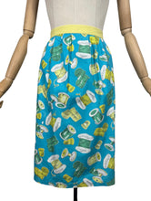 Load image into Gallery viewer, Original 1950's Novelty Print Cotton Apron with Sewing Theme in Blue, Yellow and Green - Waist 38 40
