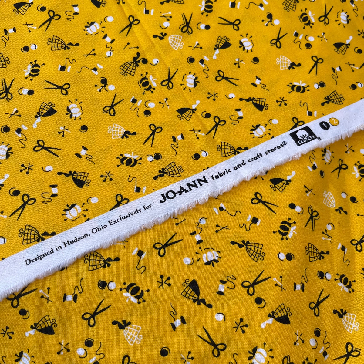 JoAnn Fabric with Sewing Notions in Black and White on Yellow 100 C