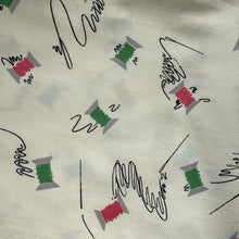 Load image into Gallery viewer, Original 1940’s Novelty Print Cotton Dress Fabric in Buttermilk with Cotton Reels in Pink and Green and Black Sewing Needles and Thread
