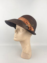 Load image into Gallery viewer, Original 1930s Brown Straw Cloche Hat with Rust Coloured Polka Dot Ribbon Trim and Metal Feather Trim
