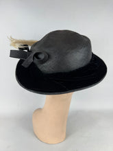 Load image into Gallery viewer, Original Early 20th Century Black Straw Hat with Velvet Covered Brim and Ivory Coloured Feather Trim *
