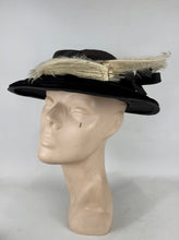 Load image into Gallery viewer, Original Early 20th Century Black Straw Hat with Velvet Covered Brim and Ivory Coloured Feather Trim *
