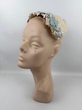 Load image into Gallery viewer, Original 1950&#39;s Ice Blue and Ivory Lacquered Raffia Half Hat with Petal Trim and Velvet Bow
