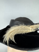 Load image into Gallery viewer, Original Early 20th Century Black Straw Hat with Velvet Covered Brim and Ivory Coloured Feather Trim *
