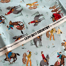 Load image into Gallery viewer, Cowboy Country by Riley Blake - Cowboy Themed Print with Horses and Wagons on Cream - 100% Cotton Dressmaking Fabric - 42&quot; x 70&quot;
