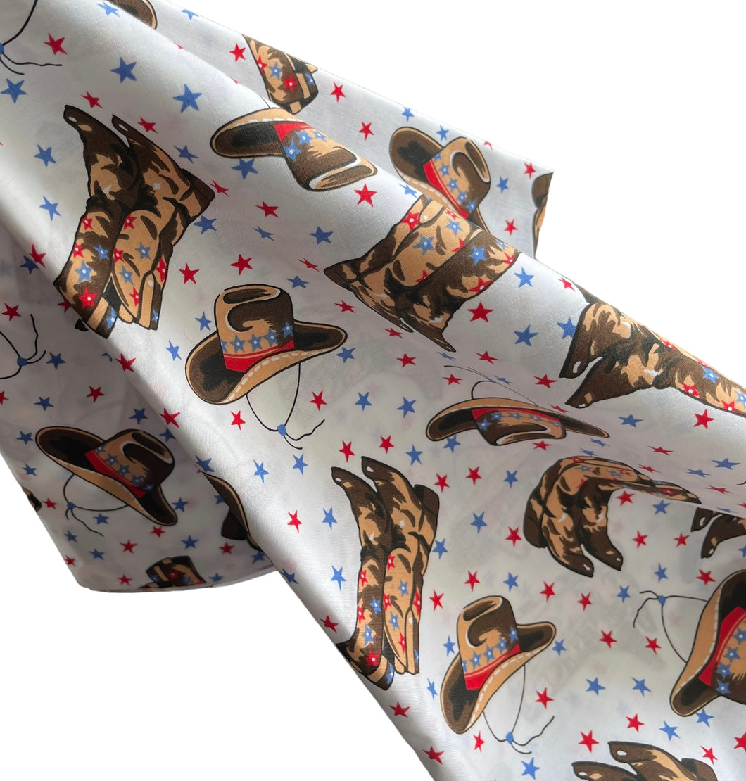 100% Cotton Dressmaking Fabric - White with Cowboy Print in Brown, Red and Blue with Stars - 58