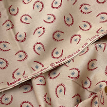 Load image into Gallery viewer, Rawhide by Moda Featuring Red Horseshoes and Blue Stars on Brown - 100% cotton Dressmaking Fabric - 42&quot; x 94&quot; *
