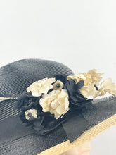 Load image into Gallery viewer, Original 1930s Black and Cream Lacquered Straw Hat with Velvet Floral Trim
